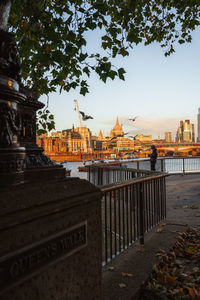 Bridge over river against buildings in city