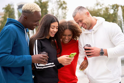 Young couple standing on mobile phone