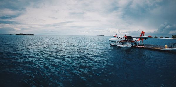 Boats sailing in sea against sky