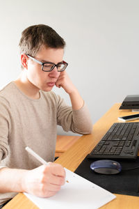 Midsection of man sitting on table