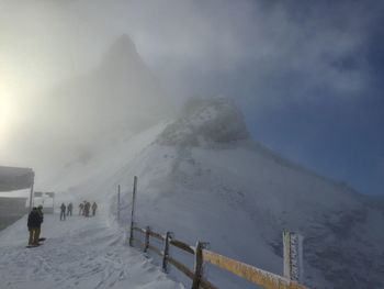 Scenic view of snow covered mountains against sky