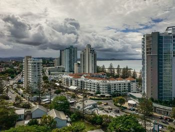 Buildings against cloudy sky