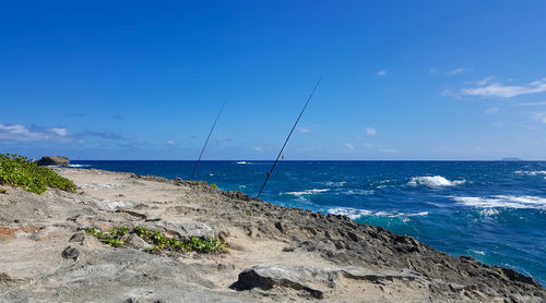 Scenic view of beach against blue sky