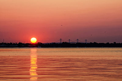 Scenic view of sea against orange sky