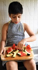 Midsection of boy holding watermelon