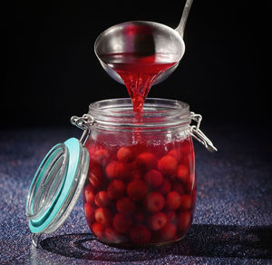 Close-up of strawberries in glass jar on table