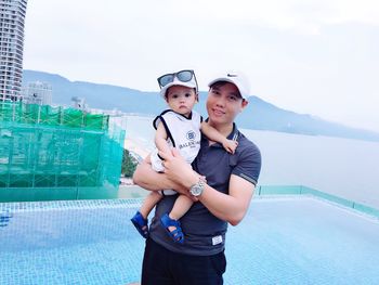 Portrait of young couple standing in swimming pool