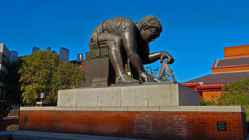 Low angle view of statue against blue sky