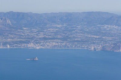 Scenic view of sea and mountains against sky