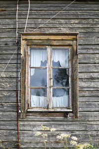 Low angle view of window of abandoned building