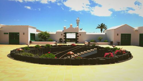 House in yard against sky