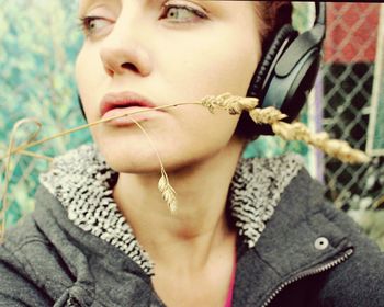 Portrait of beautiful woman looking away while wearing headphones