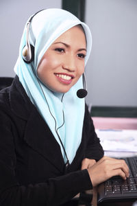 Female customer service representative using computer in office