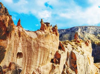 Panoramic view of rock formations against cloudy sky