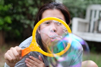 Close-up of woman blowing bubbles