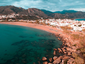 Aerial view of sea and buildings in city