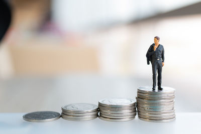 Close-up of figurine of coins
