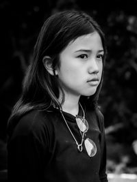 Close-up portrait of young woman standing outdoors