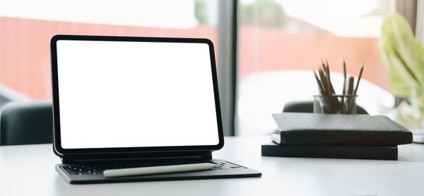 Close-up of laptop on table at home