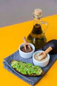 Ingredients for healthy avocado toast. ripe hass avocado, wholegrain bread, sesame flax seeds oil. 