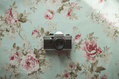 Old camera on a flowered background