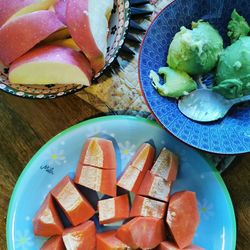High angle view of chopped fruits in bowl on table