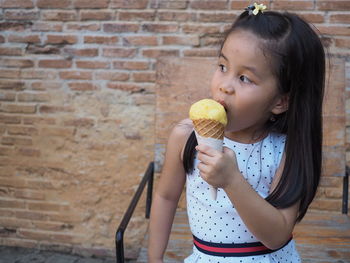 Cute girl holding ice cream outdoors