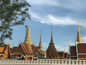 Low angle view of temple against cloudy sky