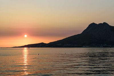 Scenic view of sea and mountains during sunset