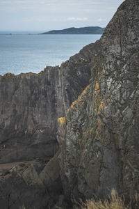 Rock formations by sea against sky