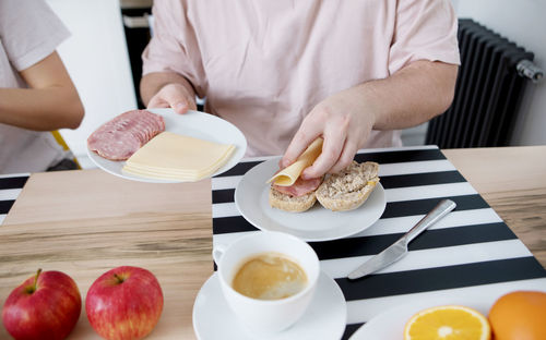 Midsection of woman preparing food on table