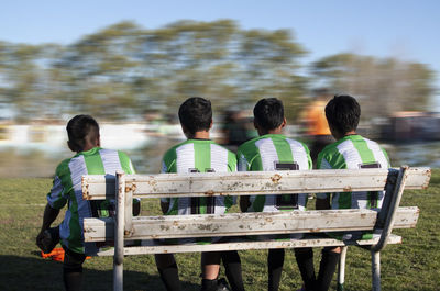 Young soccer players sitting on a bench