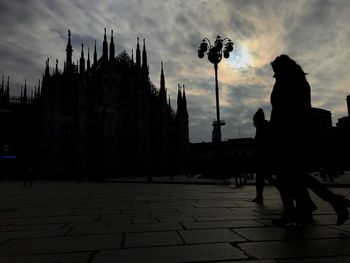 Silhouette of cityscape against sky