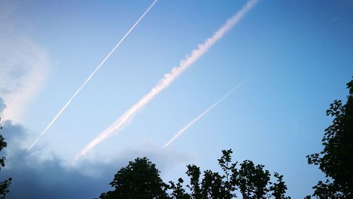 Low angle view of vapor trails in sky