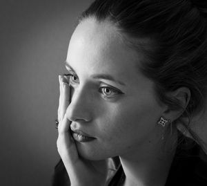 Close-up portrait of young woman looking away