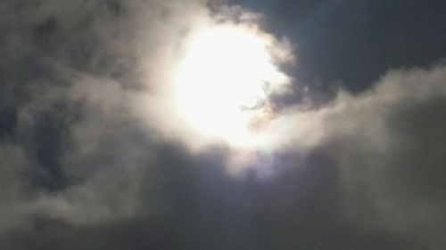 Low angle view of sun shining in sky