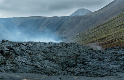 Scenic view of volcanic mountain against sky