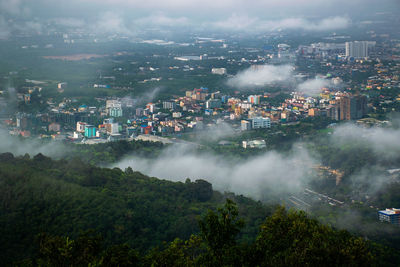 High angle view of buildings and trees in city