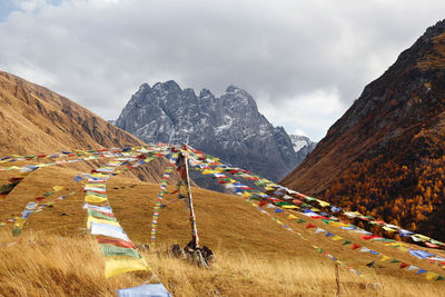 Colorful autumn landscape with tibetan prayer flags on foreground. 