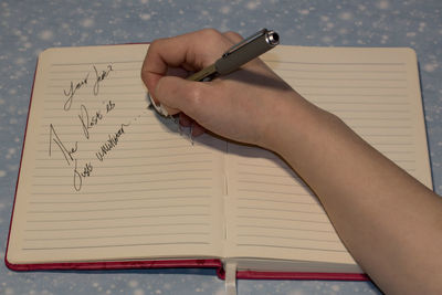 Low section of person reading book on paper