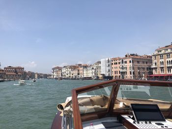 Buildings by sea against sky in city