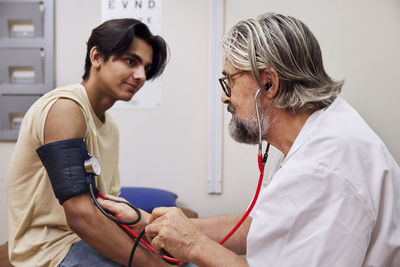 Doctor measuring patient's blood pressure