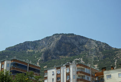 Low angle view of buildings against mountain range