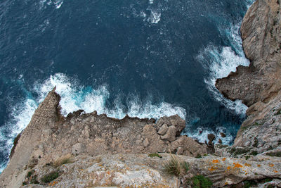 High angle view of rock formations by sea