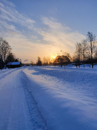 Snow covered field against sky