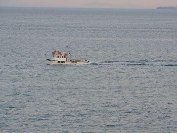 Boat sailing in sea against sky