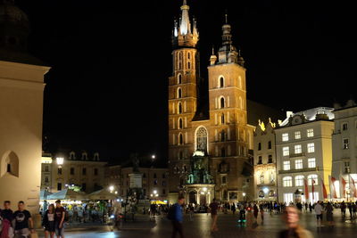 Group of people in front of building at night