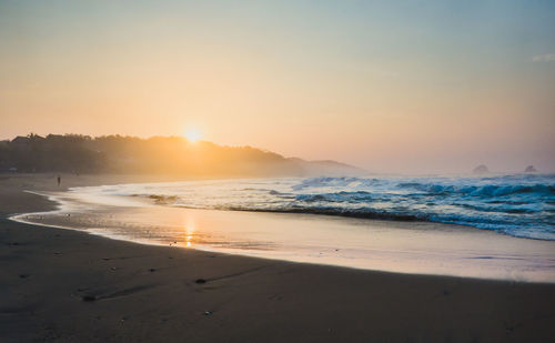 View of beach against sky during sunset