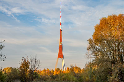 Low angle view of tower against sky during autumn