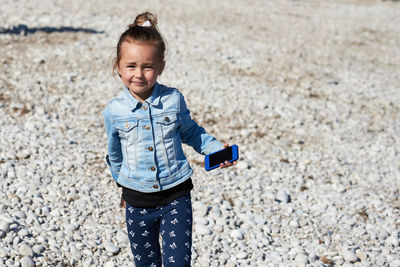 Portrait of smiling girl standing on beach